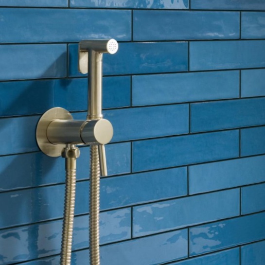 Vos Gold Douche Set with Sprayer, Hose and Wall Bracket Lifestyle Image of Wall Mounted Gold Handheld Bidet Spray Set