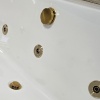 Close-up of Whirlpool Jets in Brushed Brass Close-up of Whirlpool Jets in Brushed Brass